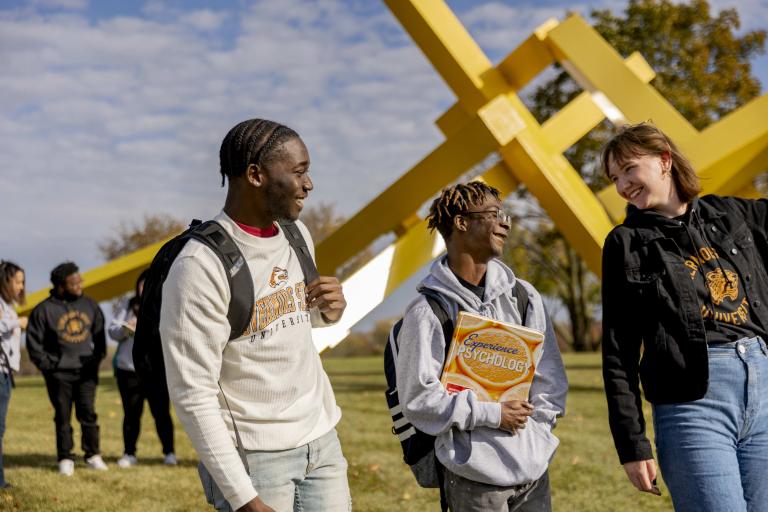 Group of students walking and talking outdoors