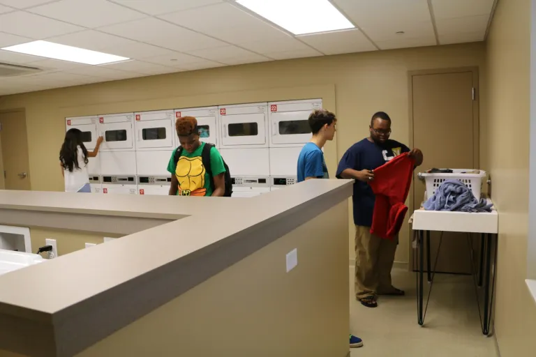 Students in Prairie Place Laundry Room