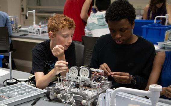Two middle school aged students working on a science project