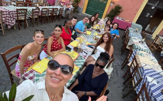 Honors College students and faculty enjoying a farewell dinner during a faculty-led study abroad program in Italy.